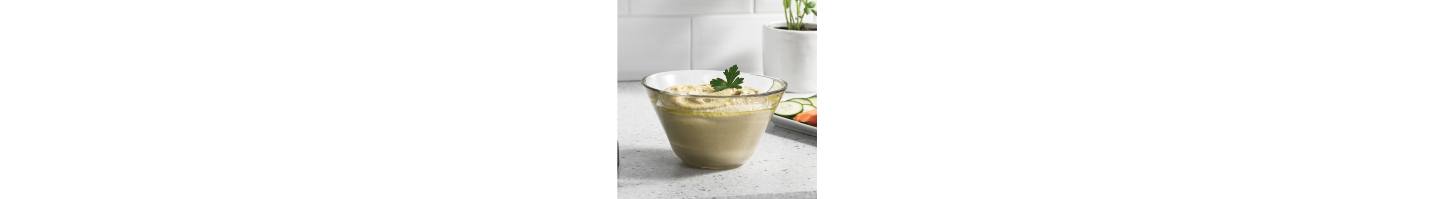 Hummus in clear glass bowl