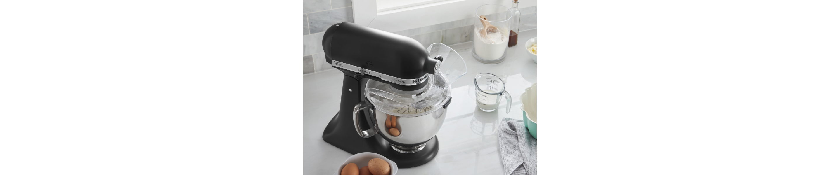 KitchenAid® stand mixer and baking ingredients in bowl with pouring shield