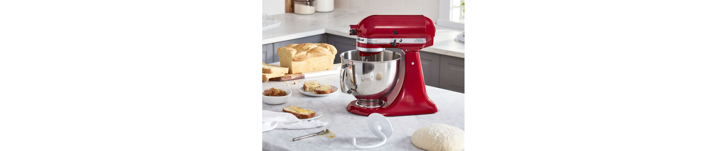 KitchenAid® stand mixer with dough hook and homemade bread on counter