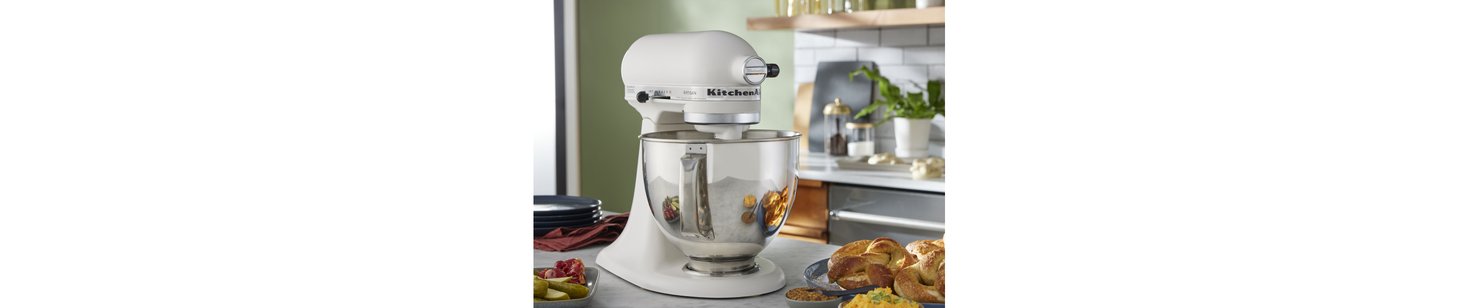 KitchenAid® stand mixer with homemade rolls on counter