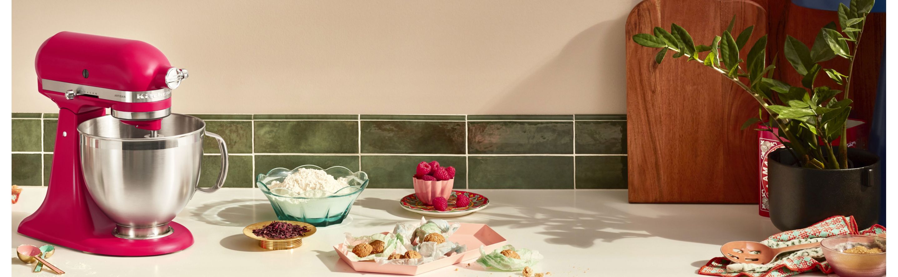 KitchenAid® stand mixer with stainless mixing bowl on countertop with ingredients