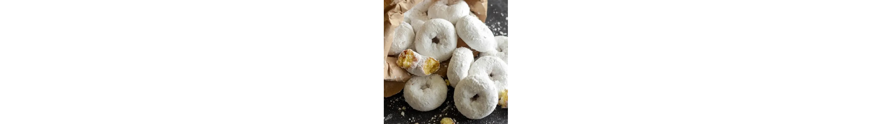 Medium-sized donuts covered in powdered sugar