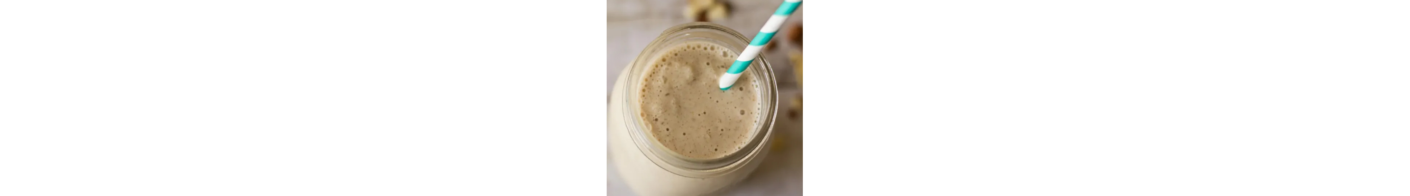 A vanilla drink in a mason jar with a blue and white straw