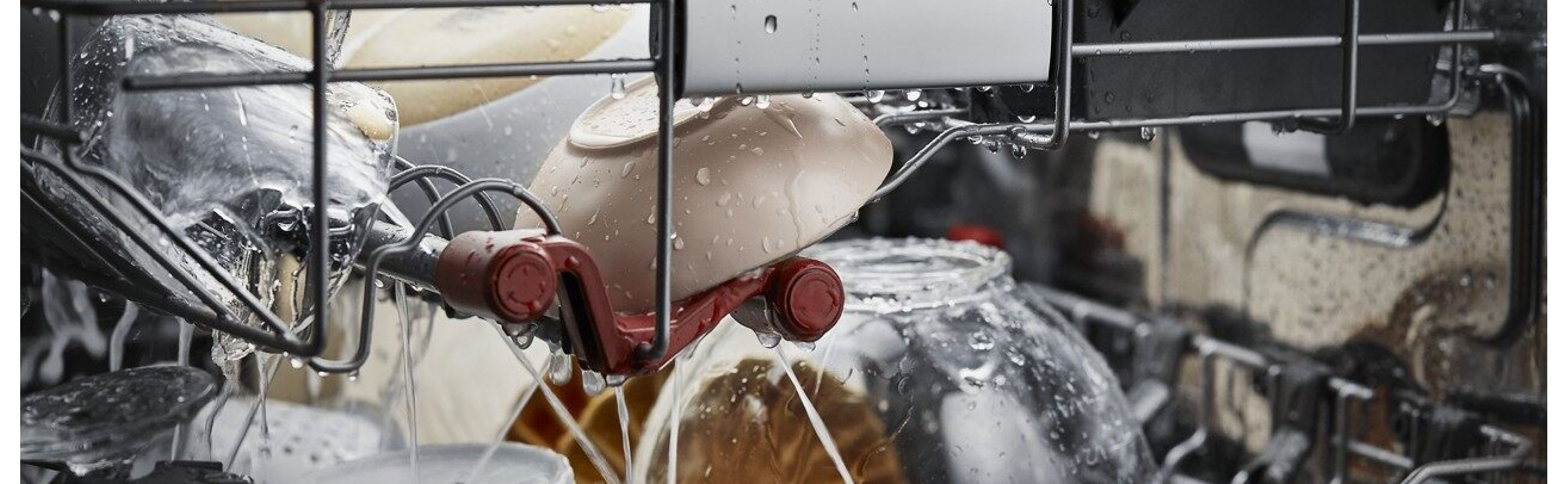 A closeup of the interior of a KitchenAid® dishwasher during a wash cycle.