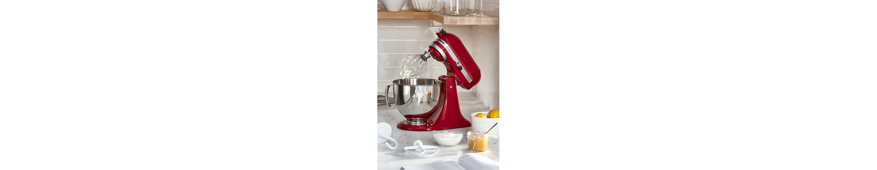 Red KitchenAid® stand mixer on granite countertop with batter on the whisk