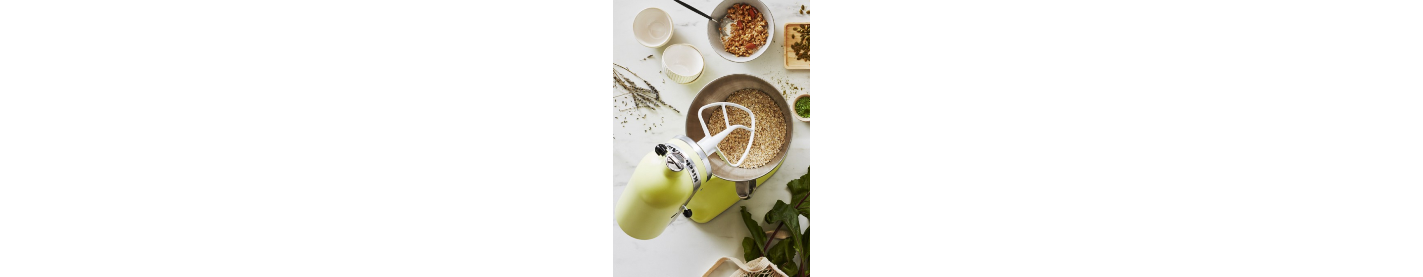 Birds-eye view of lime green KitchenAid® stand mixer with bowl full of crumb ingredients