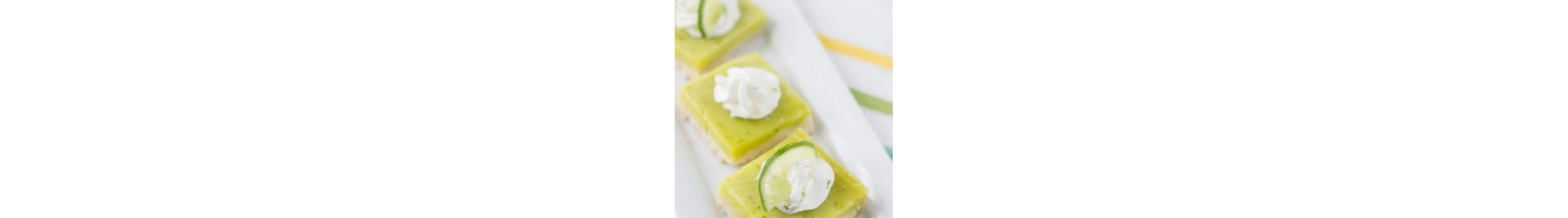 Coconut lime bars on white platter