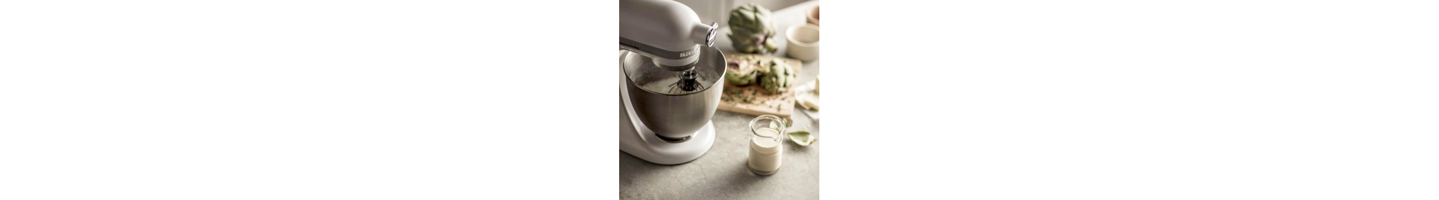 White KitchenAid® stand mixer full of ingredients 