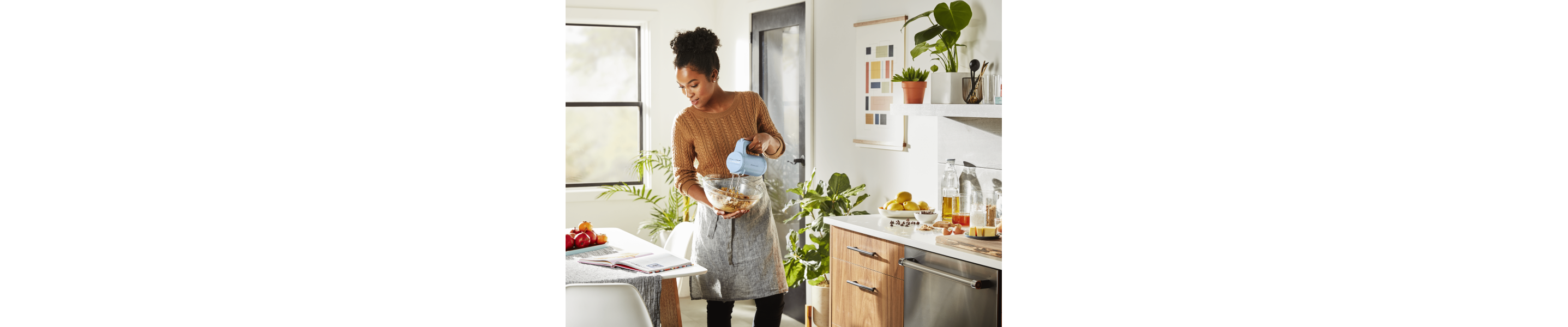 Maker using cordless KitchenAid® hand mixer to blend ingredients in bowl