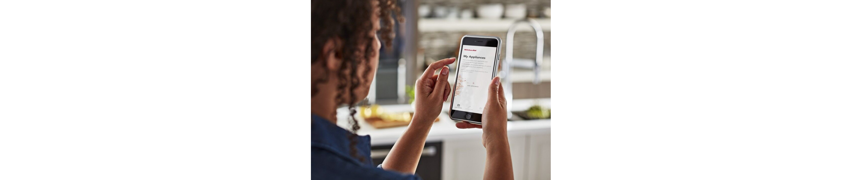 Woman using a smartphone app to control appliances