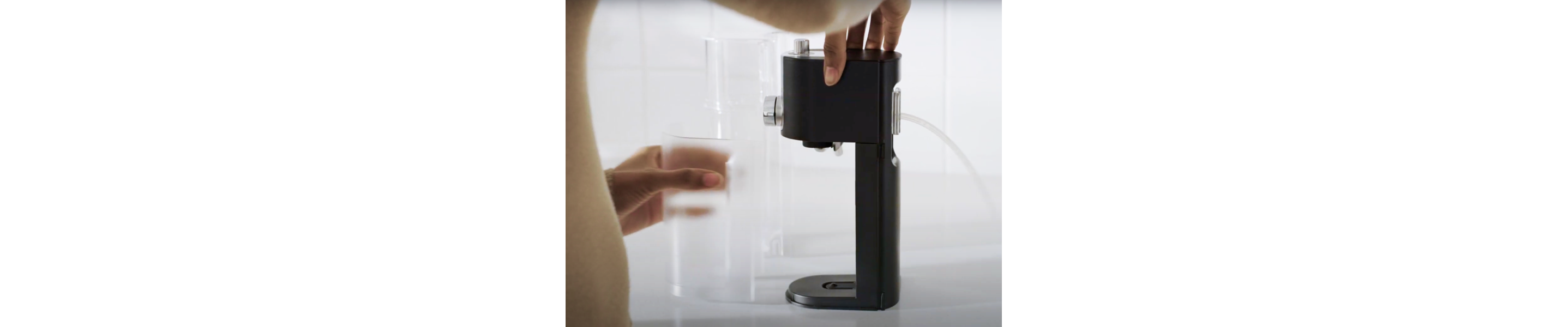 Person removing storage container from milk frother