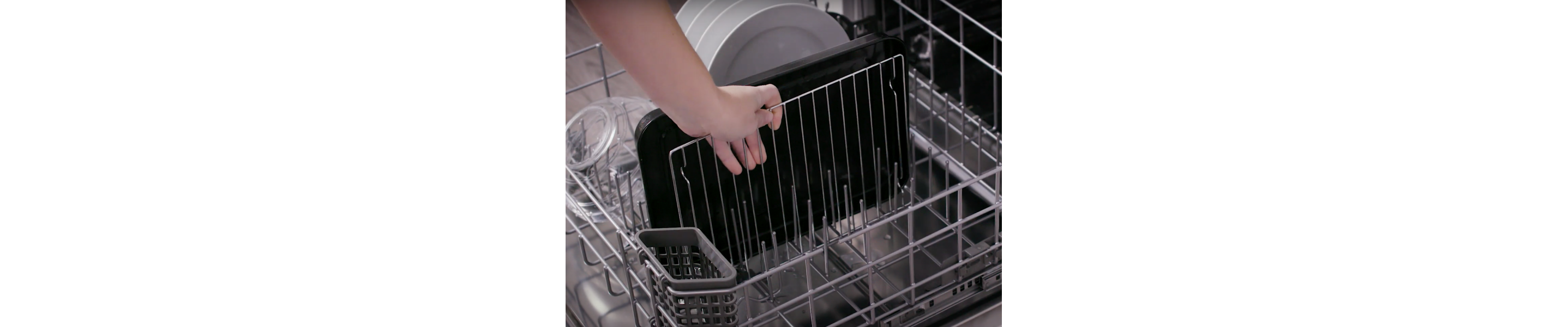 A person pulling an air fryer rack out of a dishwasher