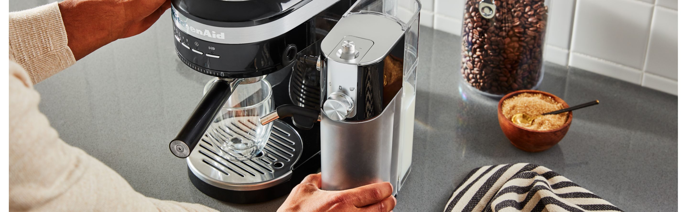 Hand replacing water tank in KitchenAid® espresso maker