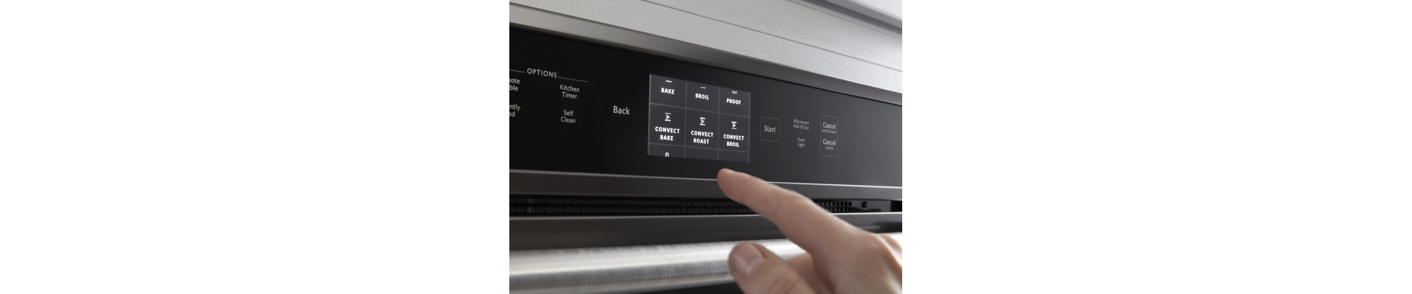 Person selecting a bake setting on a KitchenAid® oven