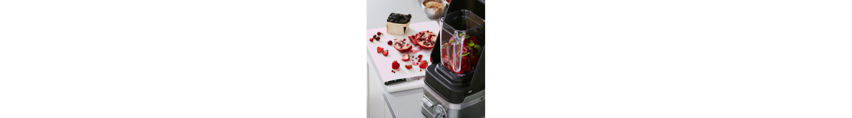KitchenAid® blender filled with strawberries, blueberries and pomegranate seeds