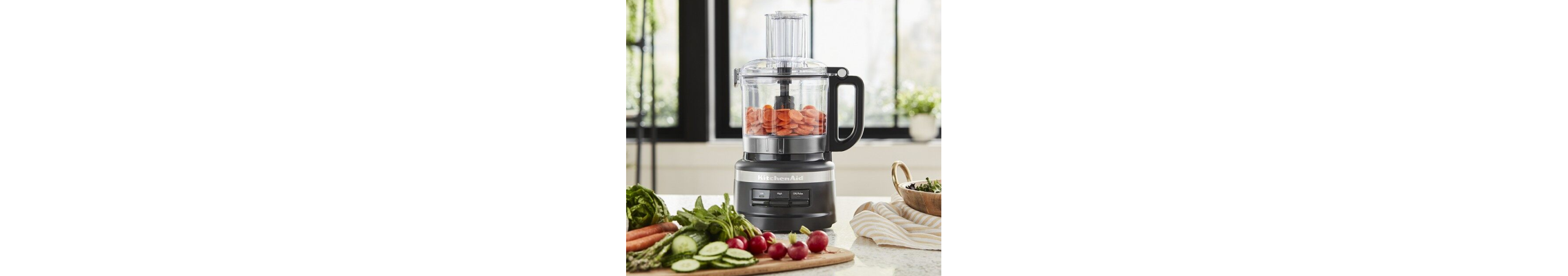 Black KitchenAid® food processor with sliced carrots for baby food
