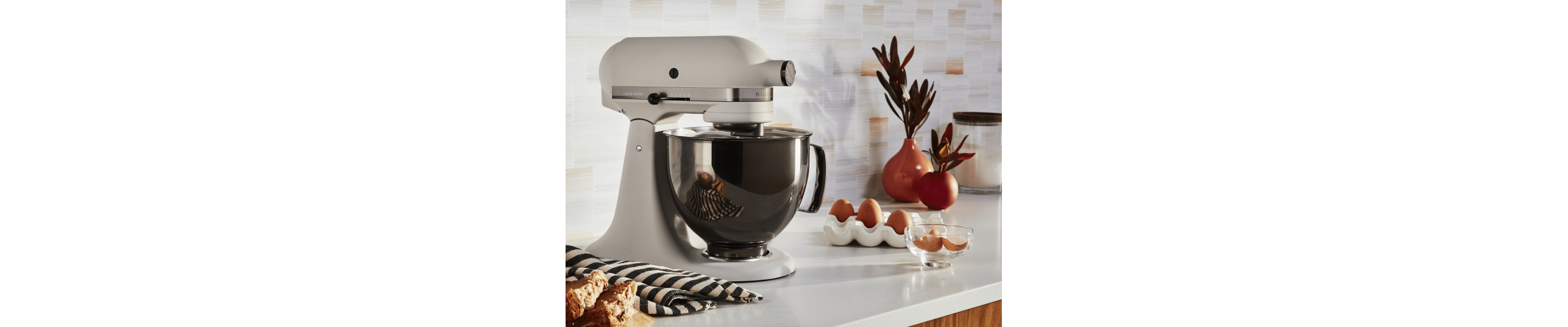 KitchenAid® stand mixer whipping egg whites in a modern kitchen.