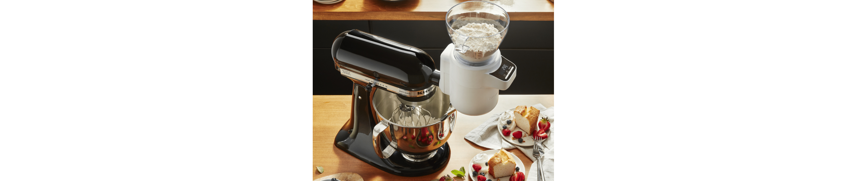 KitchenAid® stand mixer with Sifter + Scale Attachment measuring flour into stainless steel bowl