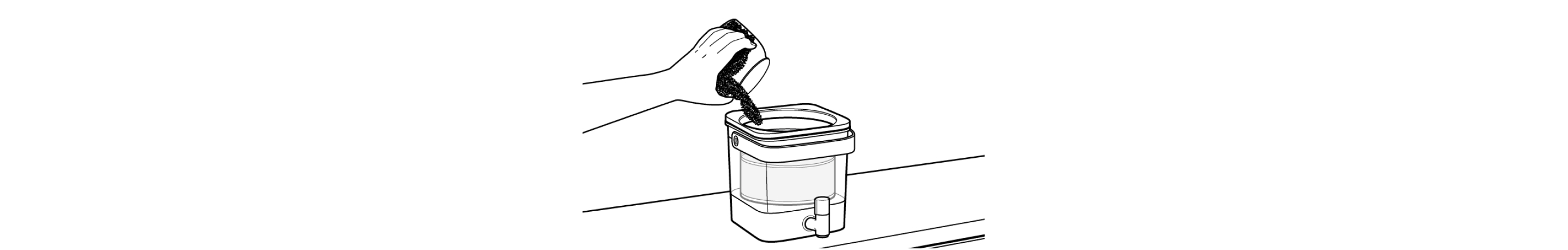 Hand pouring grounds into cold brewer filter