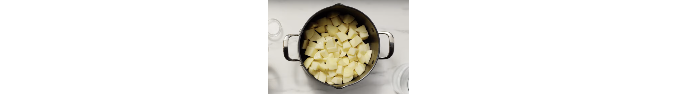 Cubed, peeled potatoes in a saucepan