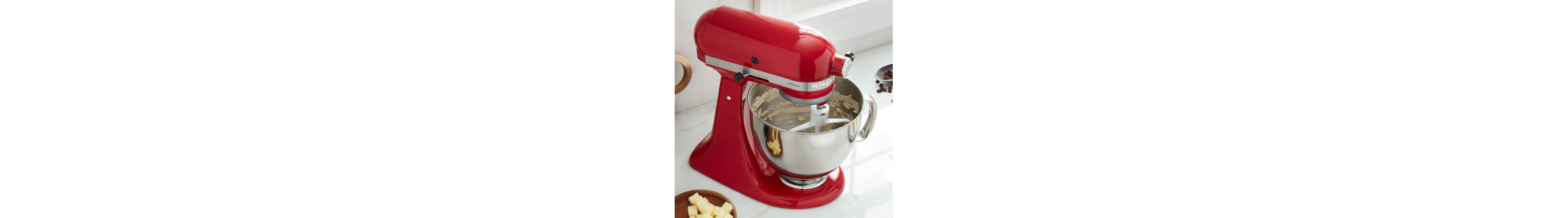 Red KitchenAid® stand mixer with stainless steel bowl and flat beater attachment