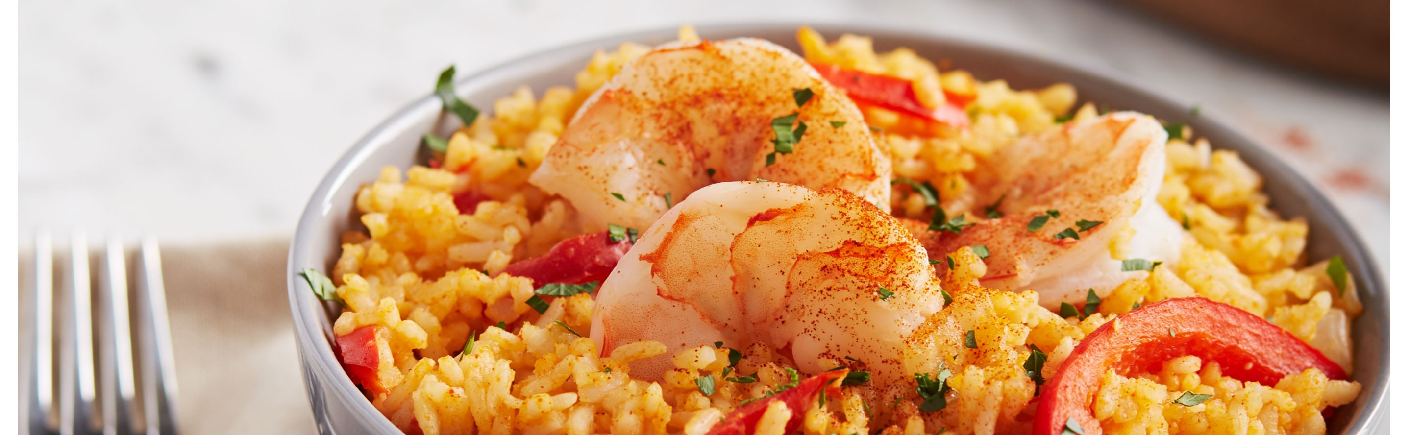 Spanish rice topped with shrimp