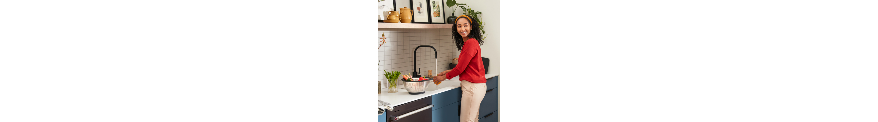 Woman rinsing ingredients in a sink