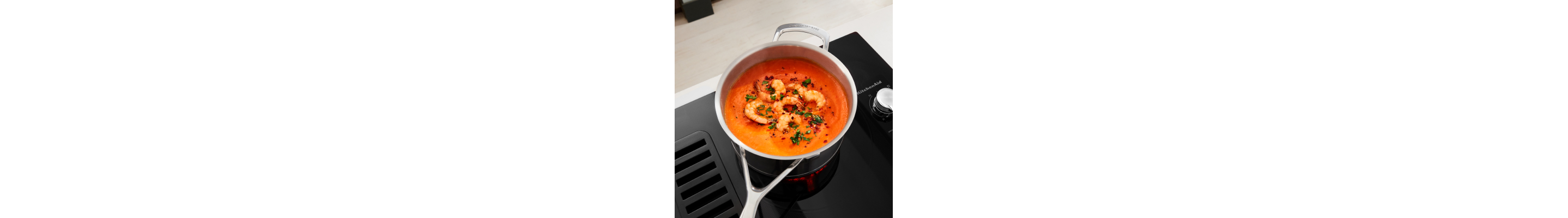 Shrimp cooking in a sauce pan on an electric stove