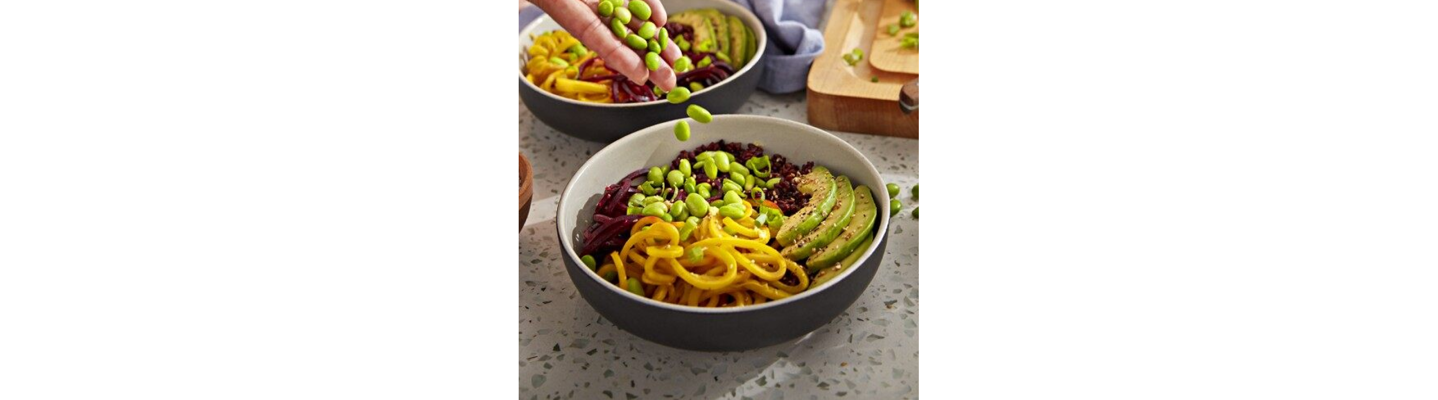 Bowls with veggie noodles, edamame, avocado and quinoa