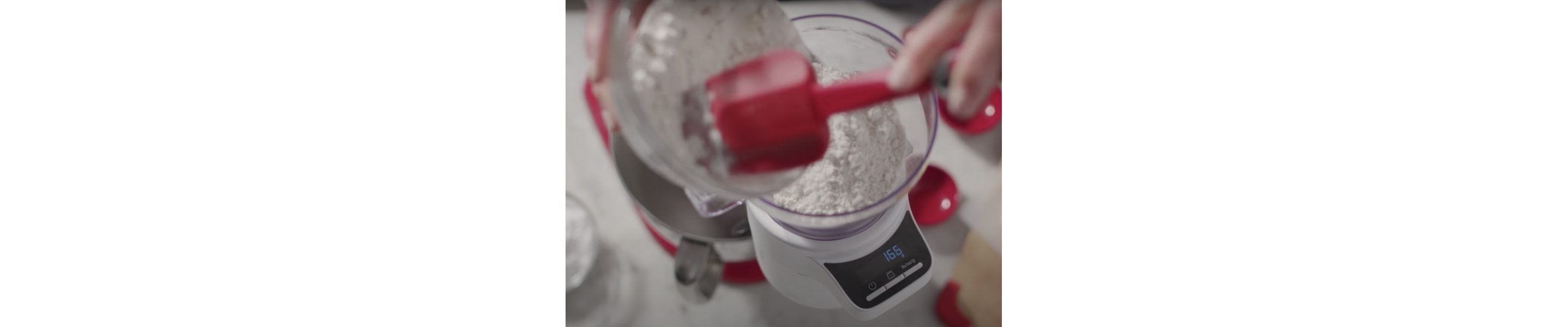 Flour being scooped into a bowl on the scale attachment