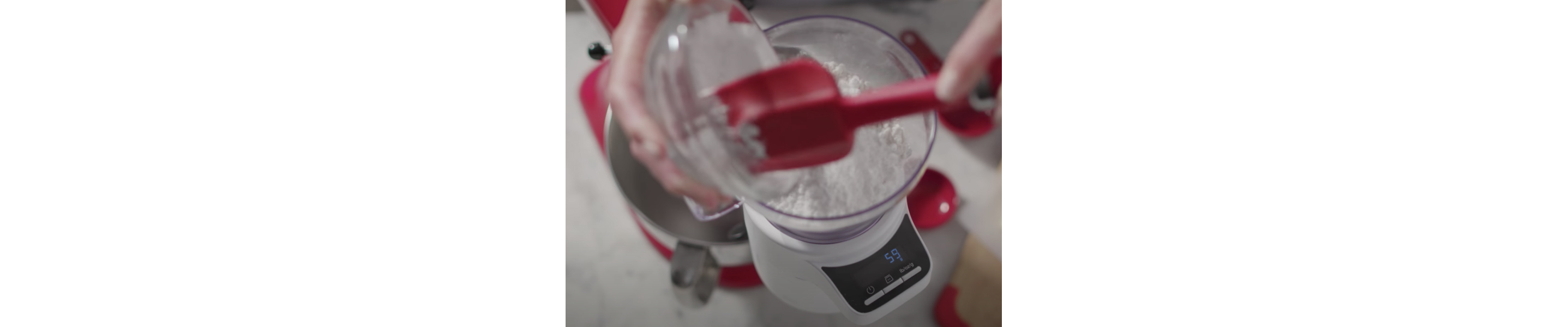 Flour being scooped into a bowl on the scale attachment