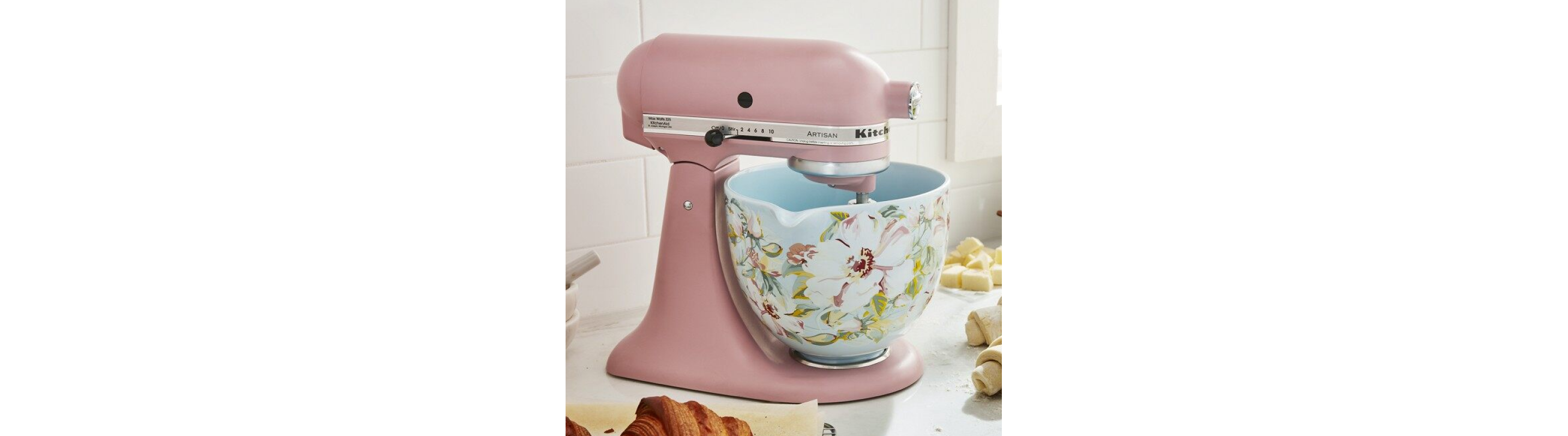 A rose gold KitchenAid® stand mixer with a flowery bowl.
