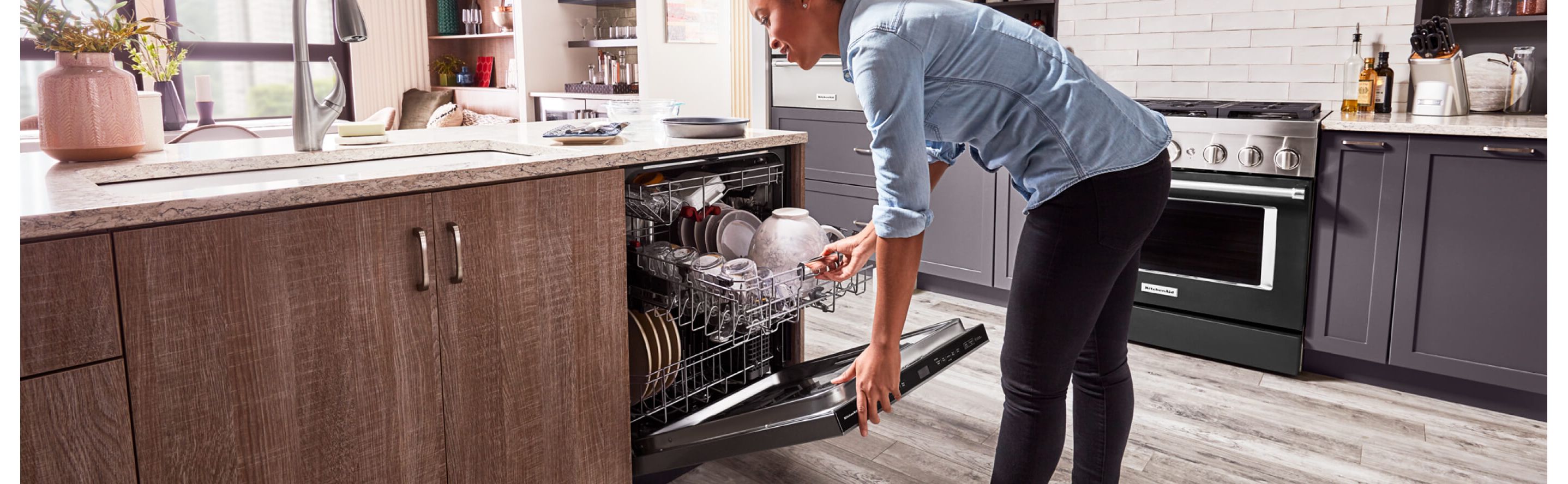 Person closing a loaded dishwasher 