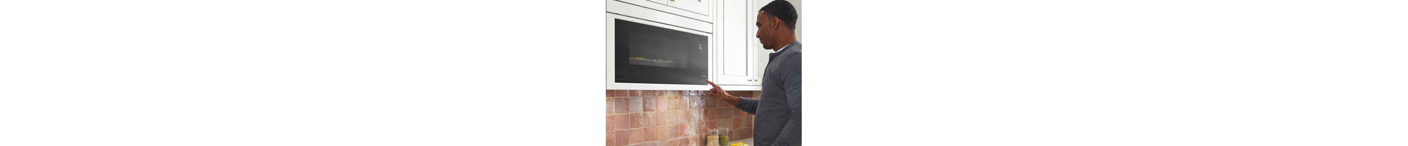 Person selecting a setting on a microwave