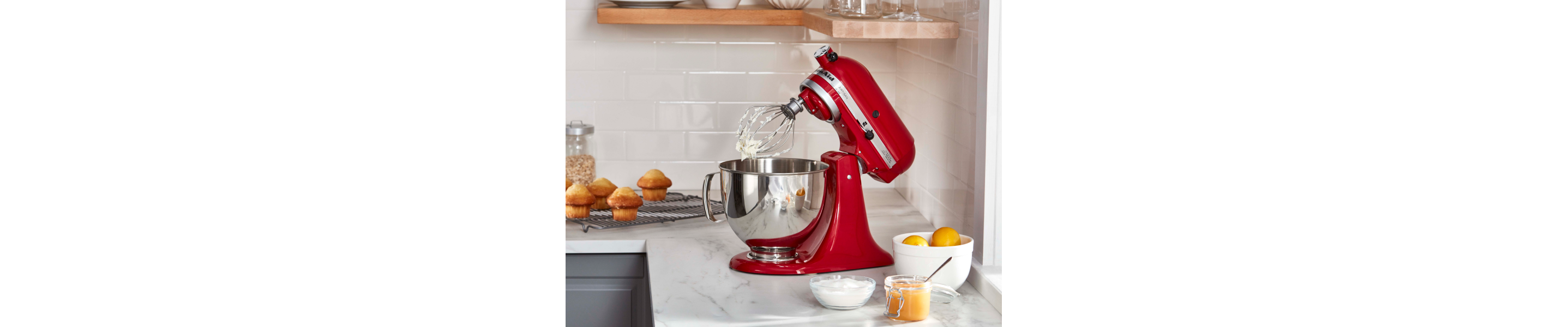 A KitchenAid® stand mixer with whipped egg whites in a modern kitchen.