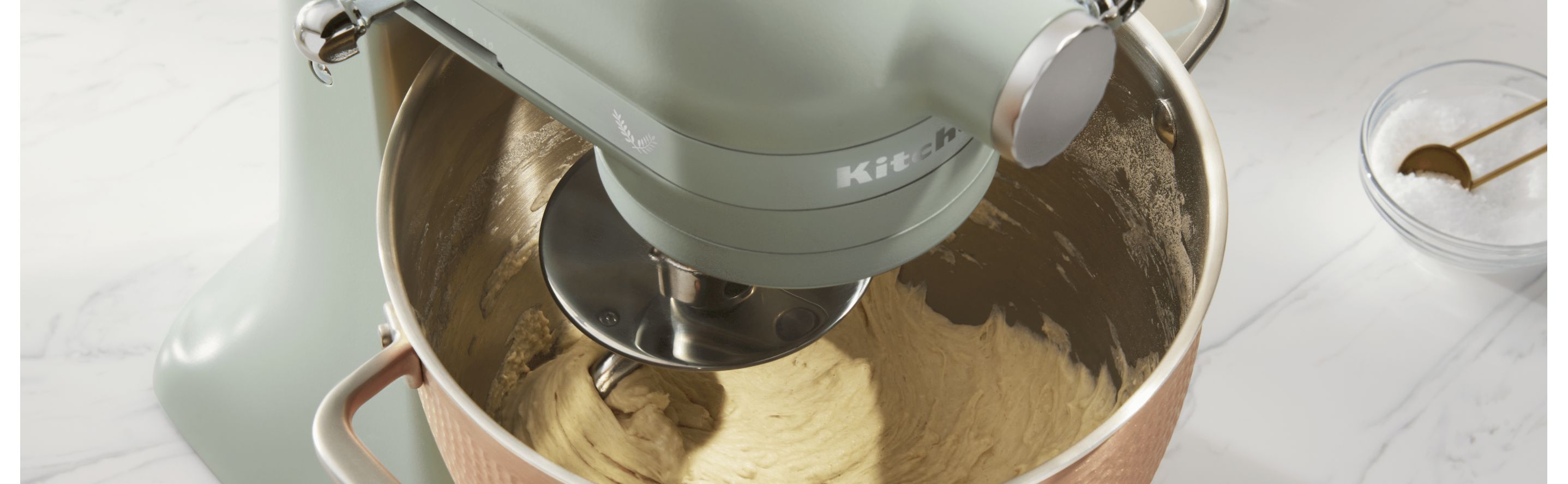 KitchenAid® stand mixer with dough hook mixing dough