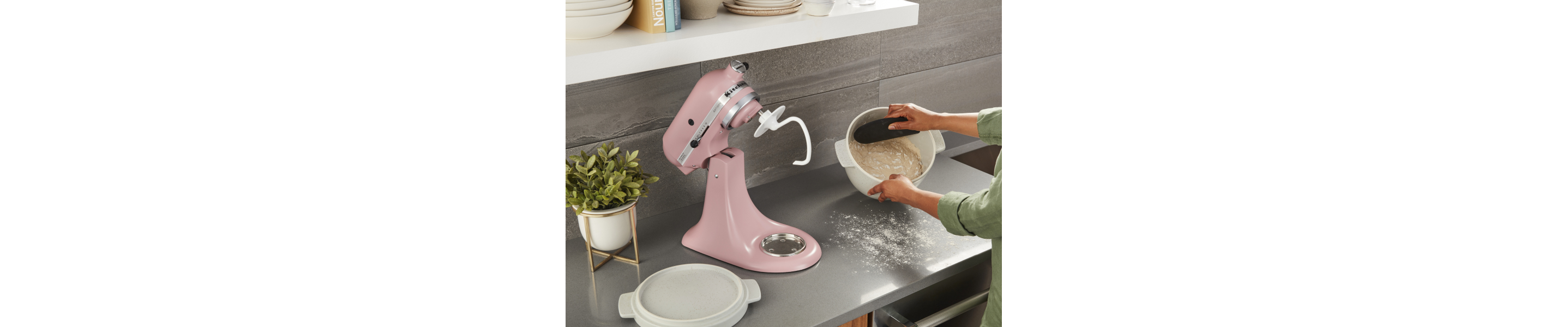 A person proofing dough made with a KitchenAid® stand mixer