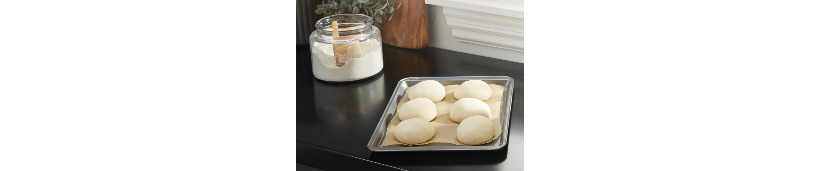 Raw dough balls on a prepared baking sheet