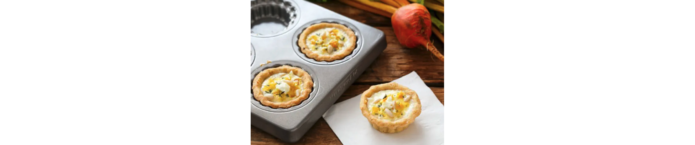 A golden beet and goat cheese quiche resting on a napkin