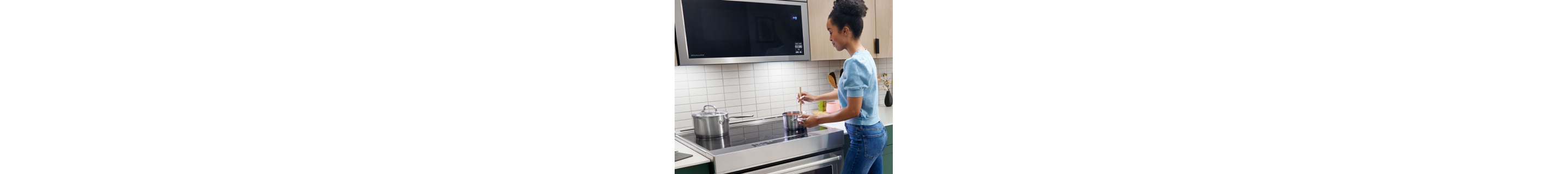Person stirring at a cooktop