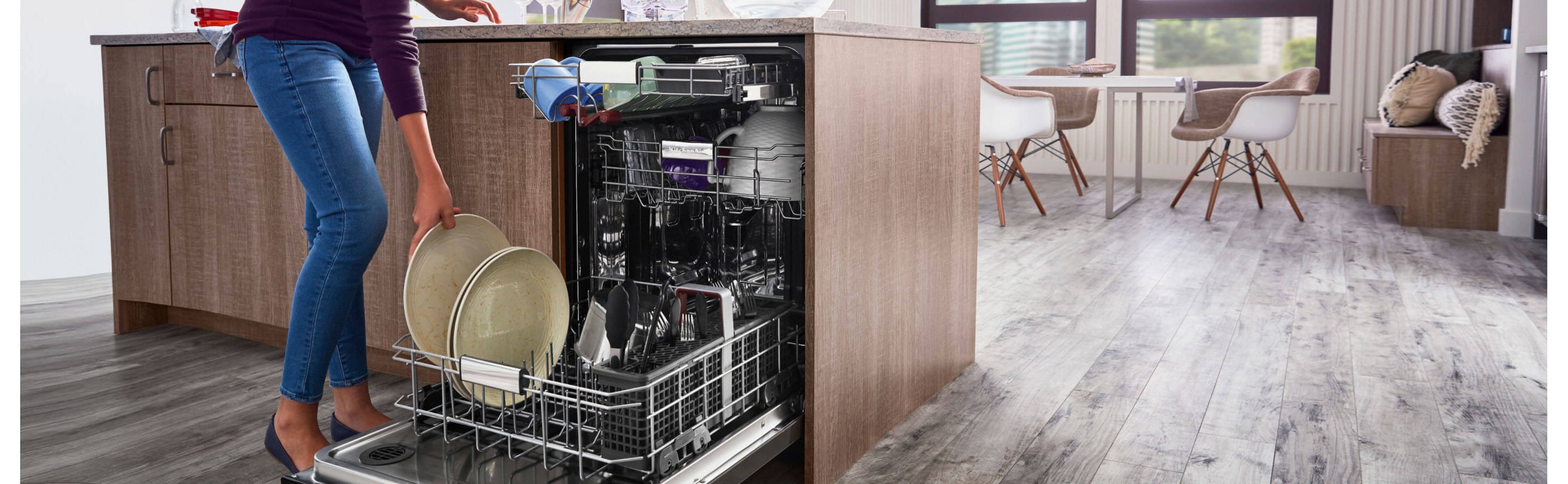 Person loading dishes into a dishwasher