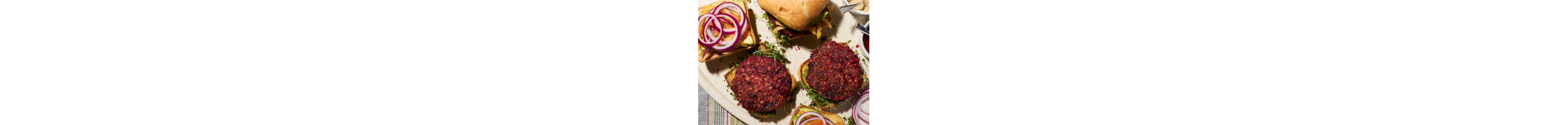 A plate of assembled and partially-assembeled black bean burgers.