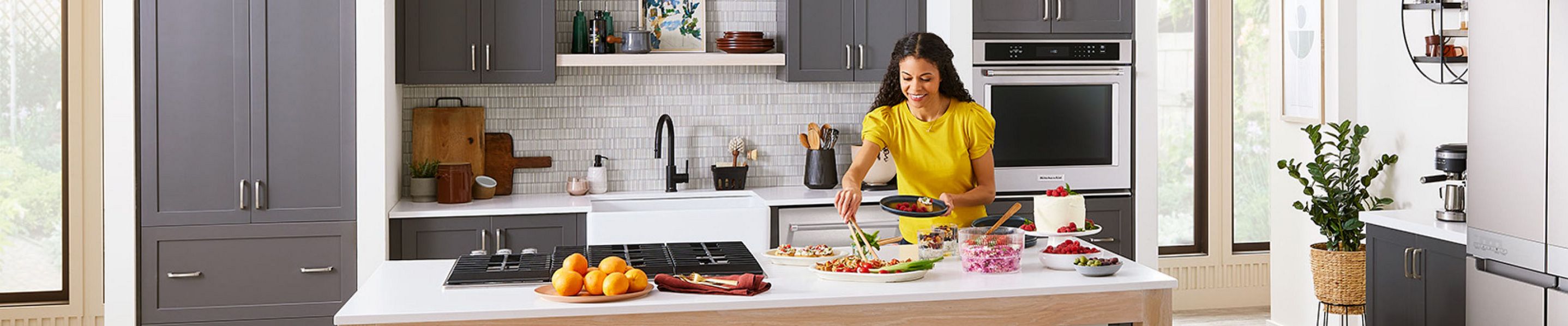 Woman cooking an a kitchen with KitchenAid suite